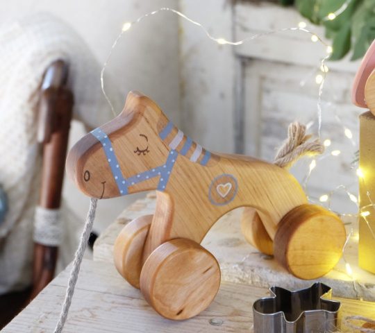 Wooden horse toy has a sensitive heart which helps him dream about a friend who would pull his sting. This handmade pull along toy is quality crafted and safe.