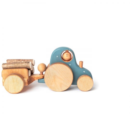 This handmade wooden tractor is really happy because he has a driver and a trailer. The driver can turn his head, uncouple the trailer and ride with the wind.