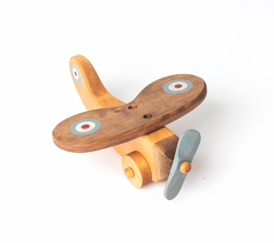 When handmade wooden toy plane is romping, his wheels and propeller are spinning. Wooden aircraft want to find his naughty pilot and teach him to pilot.