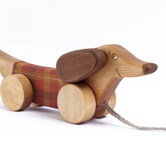 When wooden pull along dog is being pulled, he starts flapping his ears and swinging up and down with his front wheels. Handmade toy is quality crafted and safe